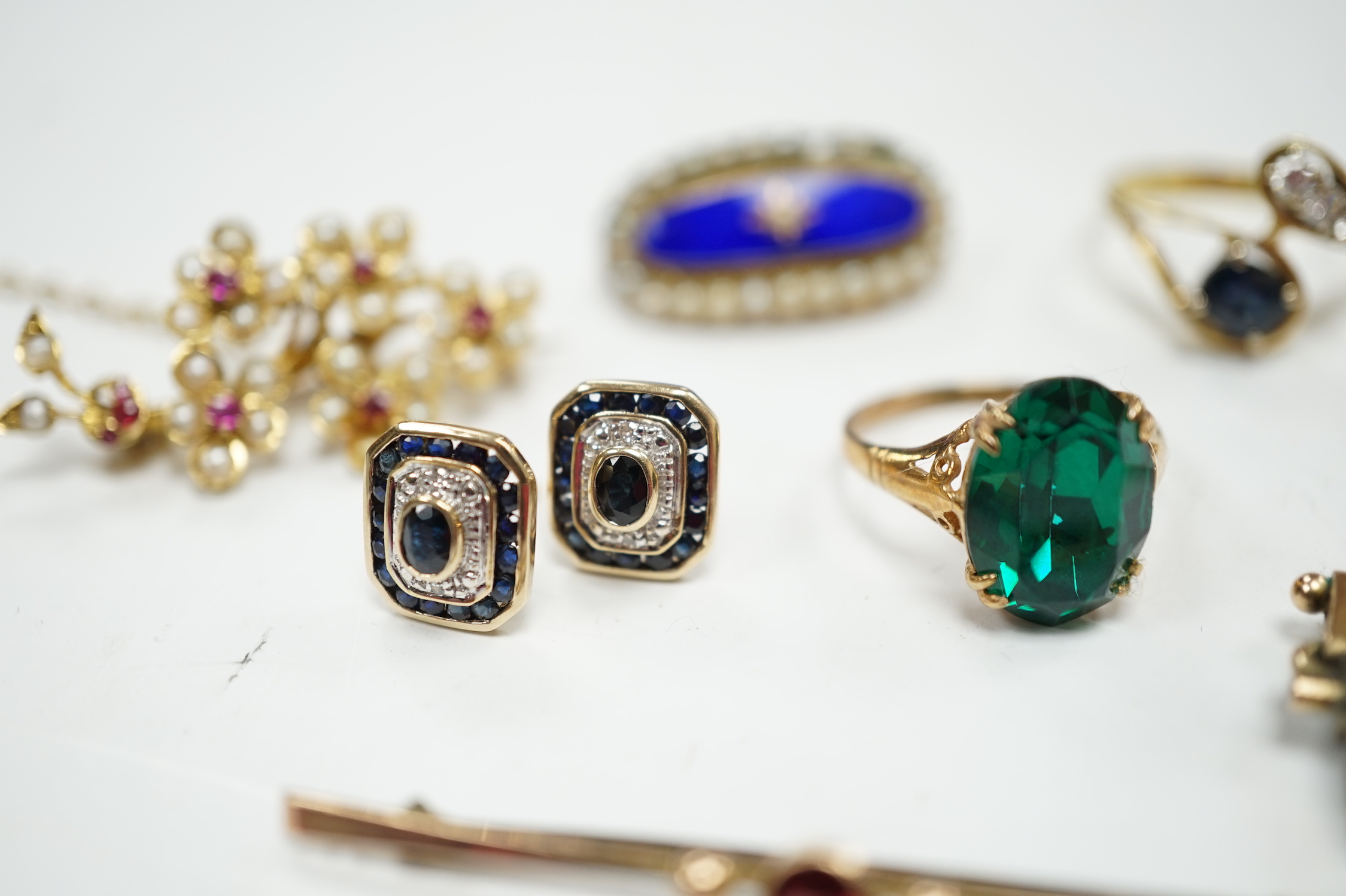 A 750 yellow metal, single stone sapphire and three stone diamond set crossover ring, size, three other yellow metal and gem set rings including a continental 875 white metal and 585 yellow metal, synthetic sapphire or s